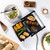 Tabletop electric grill cooking assorted meats and vegetables, shown in use.