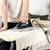 Steam iron soleplate upright showing steam on folded clothes