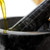Close-up of oil being poured into a dark marble mortar and pestle.