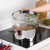 Stainless steel stock pot with glass lid on induction hob