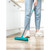 Person using a blue rubber broom to scrub wet kitchen floor