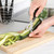 Opening a tin of pizza sauce with a black-handled can opener on a kitchen counter