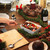 Festive table setting with roast vegetables, pudding, and champagne for Christmas meal