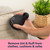 Handheld fabric shaver removing lint from a sofa cushion