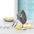 Silver hand mixer with beaters, lemon meringue pie and lemons on kitchen worktop