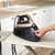Rose gold steam generator iron with water tank on ironing board