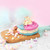 Ice cream sandwich with pink and blue waffles and colourful marshmallows on board