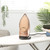 Rose gold Beldray steam iron upright on ironing board with folded clothes