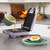 Purple waffle maker open on kitchen counter with batter being poured inside