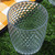 Clear textured glass tumbler on outdoor picnic blanket