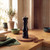 Black wooden pepper mill on kitchen worktop