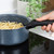 Non-stick blue saucepan with speckled finish on hob, cooking spaghetti, detachable black handle