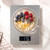Digital kitchen scale weighing a bowl of oats, berries, chia seeds and honey, display shows 176g