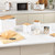 White and wood kitchen storage set with matching kettle, canisters, toaster, and microwave on worktop