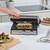 Stainless steel panini press with grilled sandwich in modern kitchen setting