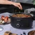 Black Salter slow cooker with glass lid shown on kitchen worktop