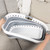Collapsible grey and white laundry basket shown from above