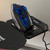 Blue and black cordless steam iron on charging base