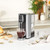 Black Salter hot water dispenser on kitchen counter with glass mug and herbal tea bags