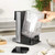 Black and stainless steel tea maker with removable water tank shown on a kitchen counter