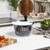 Clear plastic salad spinner with black handle on kitchen counter
