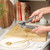 Salter manual can opener with black handles, shown in a modern kitchen setting