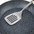 Grey speckled frying pan with stainless steel slotted turner