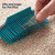 Hand using blue pet hair remover on carpet, showing fur trapped in bristles