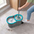 Spin mop with grey and blue bucket cleaning tiled floor, visible dirt being removed