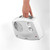 White portable fan heater being carried by handle, showing dials and Beldray branding.