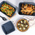 Set of non-stick blue bakeware with roast chicken, roasted vegetables, and goat cheese quiche