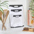 Set of three white chopping boards with black trim, stacked on kitchen worktop