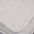 White quilted mattress protector corner close-up