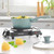 Teal saucepan with pasta and vegetables on black single hot plate hob in kitchen