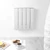 White electric radiator mounted on wall in modern living room