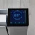 Close-up of white digital radiator with illuminated control panel display