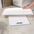 Glass digital bathroom scale with LCD display, shown with four AA batteries included.
