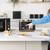 Black four-slice toaster in use on kitchen worktop, with toast, eggs and coffee nearby