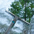 Grey and blue window squeegee cleaning soapy glass, outdoor use shown.