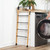 Foldable bamboo and black metal clothes airer with five rails, shown front view.