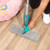 Blue spray mop cleaning light wood floor with grey chenille head, hand demonstrating use