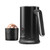 Black electric milk frother with handle next to cup of frothed hot chocolate