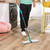Turquoise plastic pet hair remover brush with bristles and ergonomic handle