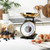 Gold colour mechanical kitchen scale with bowl, shown weighing fresh cherries