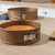 Set of three gold round springform cake tins, shown empty for baking use.