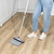 Navy and white rubber broom with handle, angled for hard floors