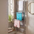 Chrome heated towel rail with folding drying rack, white and pastel towels hanging