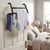 Black over door drying rack with grey socks and top, shown in bedroom setting