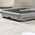 Mechanical bathroom scale with black textured platform, shown on tiled floor