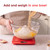 Baking ingredients being added to a bowl on red digital kitchen scales